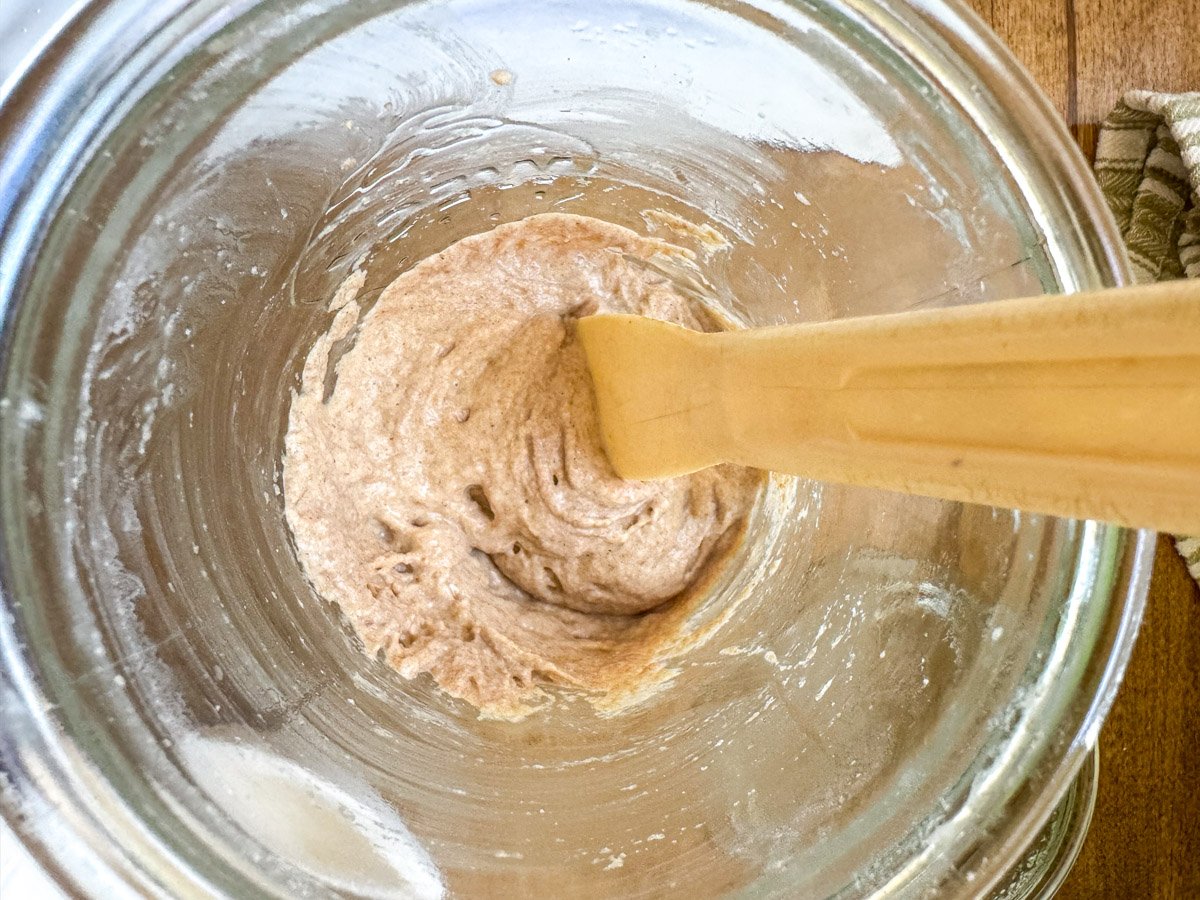 mixing sourdough starter in jar above