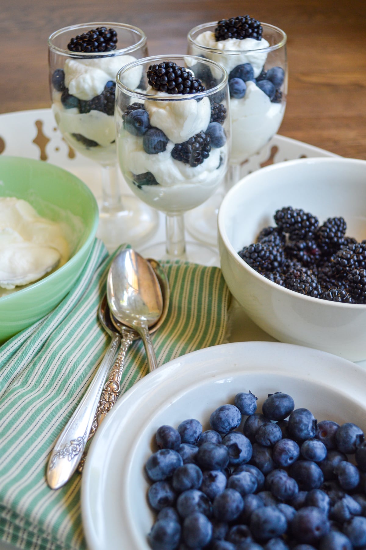 berry parfaits on tray with ingredients
