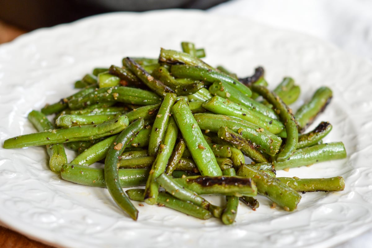 cooked garlic green beans on plate