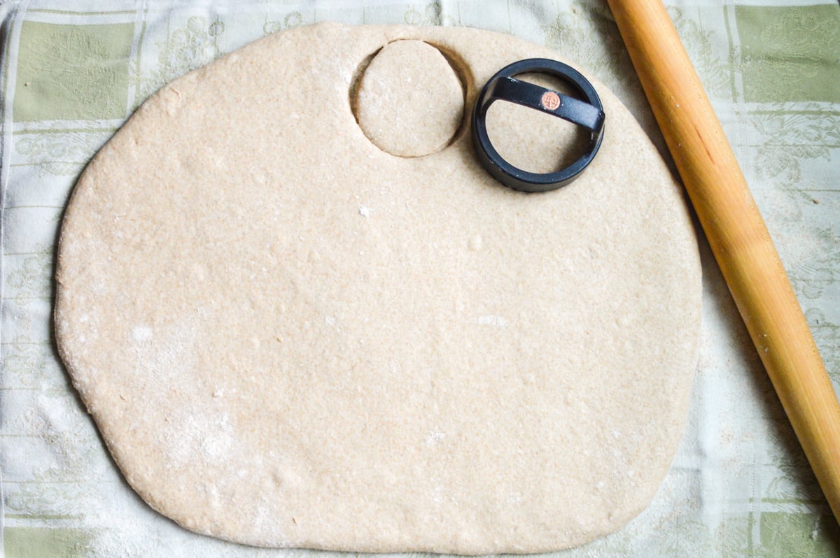 cutting out english muffin dough