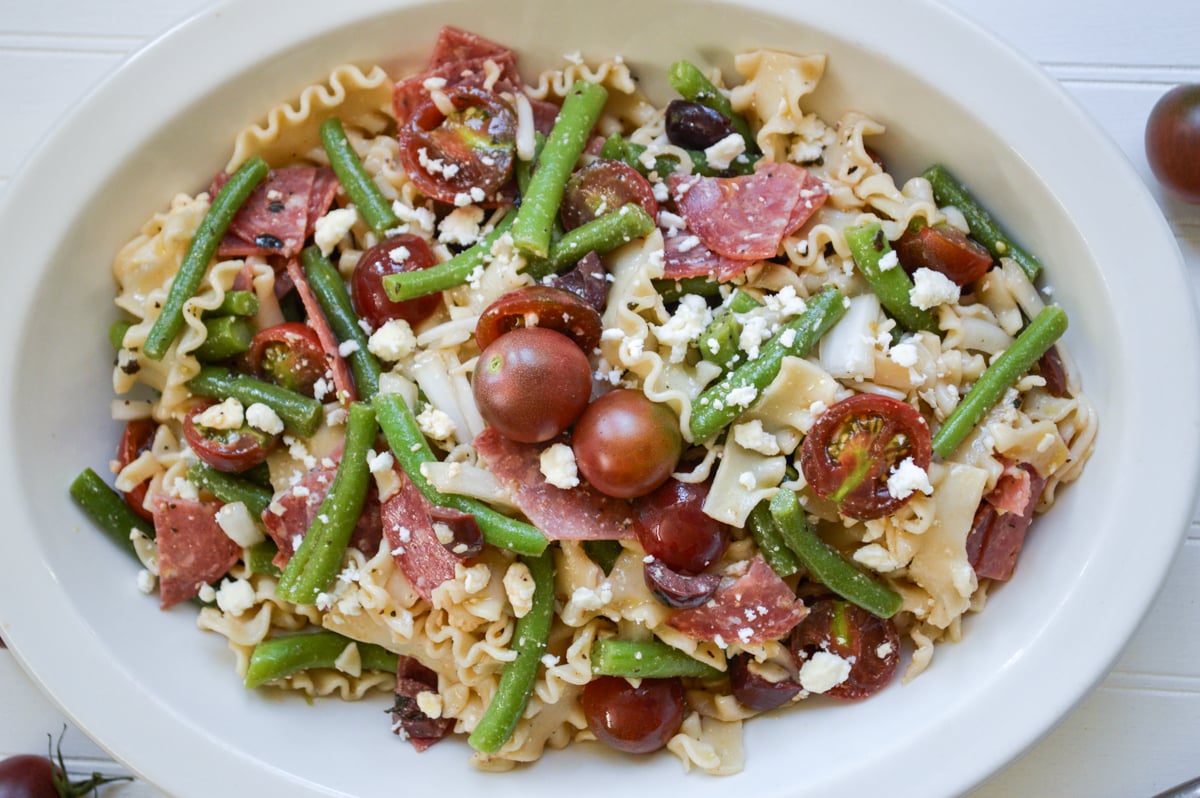 greek pasta salad in white bowl
