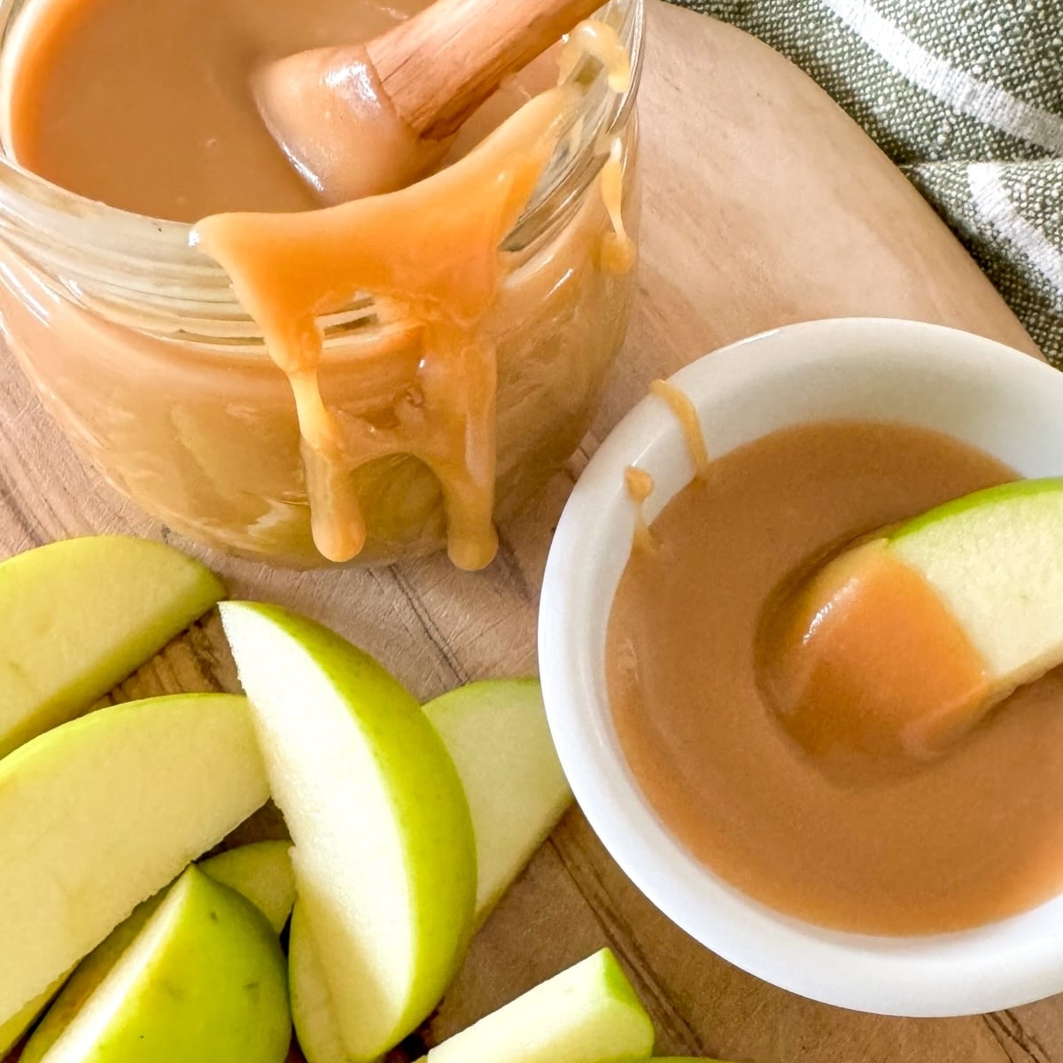 caramel dip in jar and apple dipped in bowl