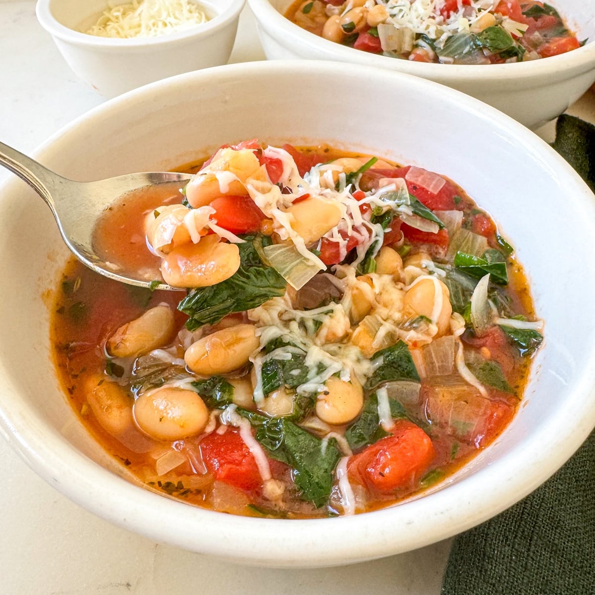 bowl of tomato white bean soup with spoon