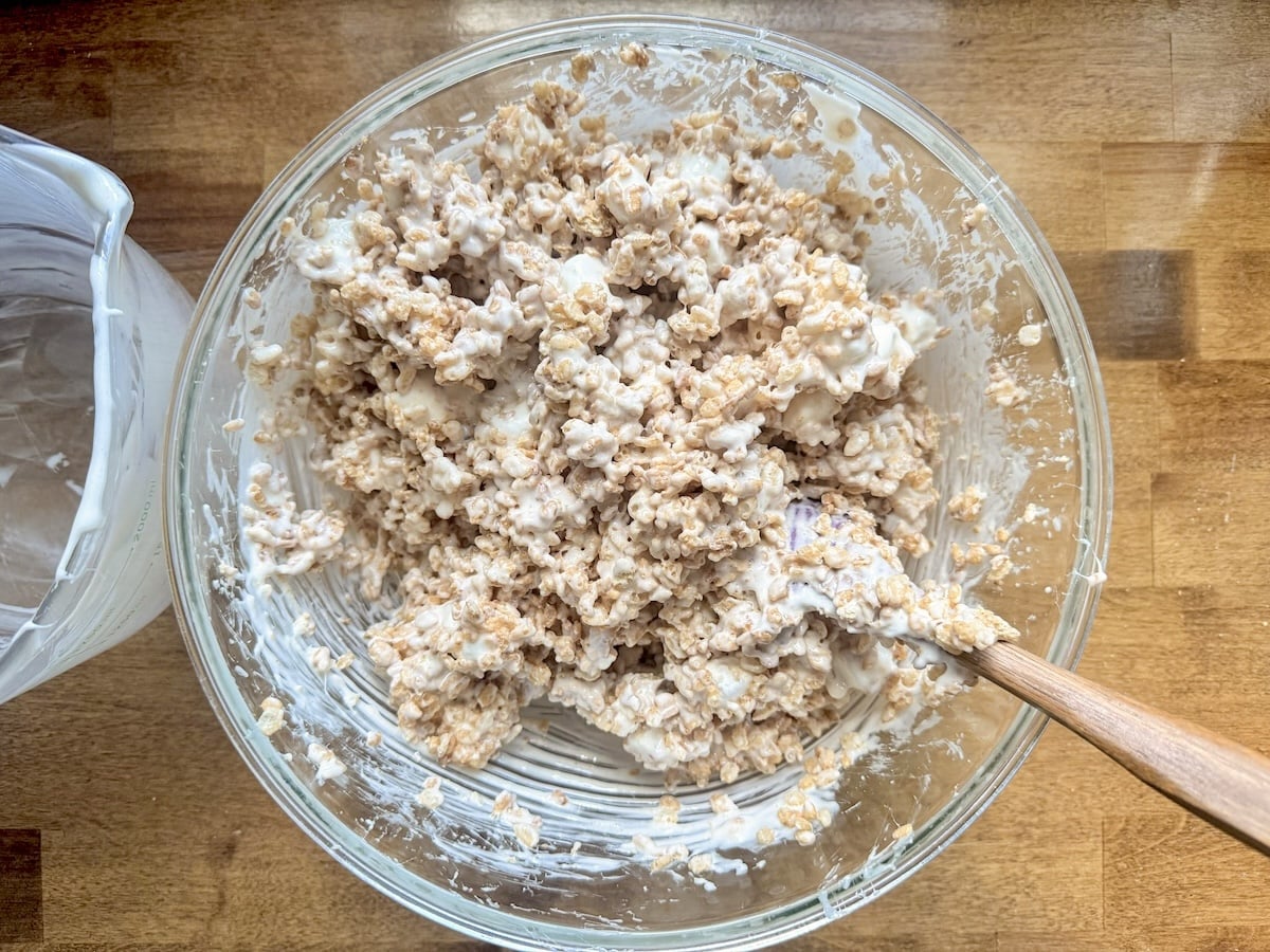 stirring cereal mixture with melted marshmallows