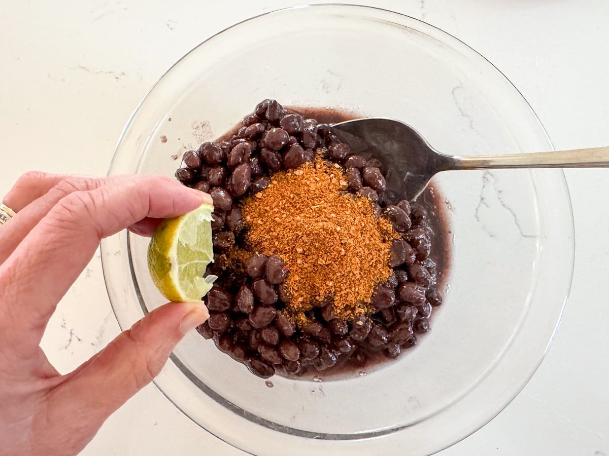 mixing beans and seasoning in a bowl
