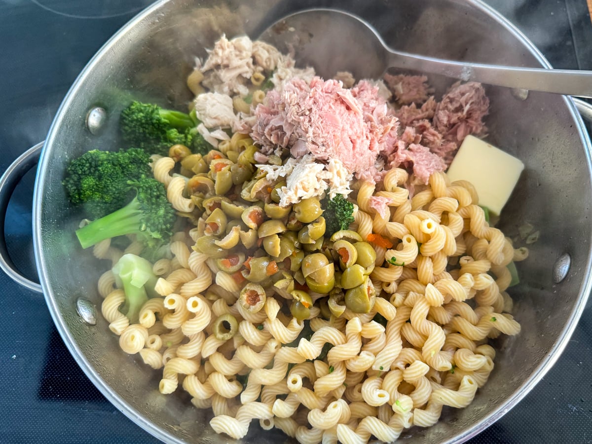 adding ingredients to tuna pasta