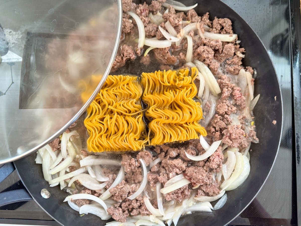 cooking ramen with onions and meat