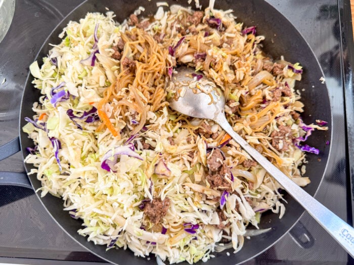 mixing all the egg roll in a bowl ingredients in pan