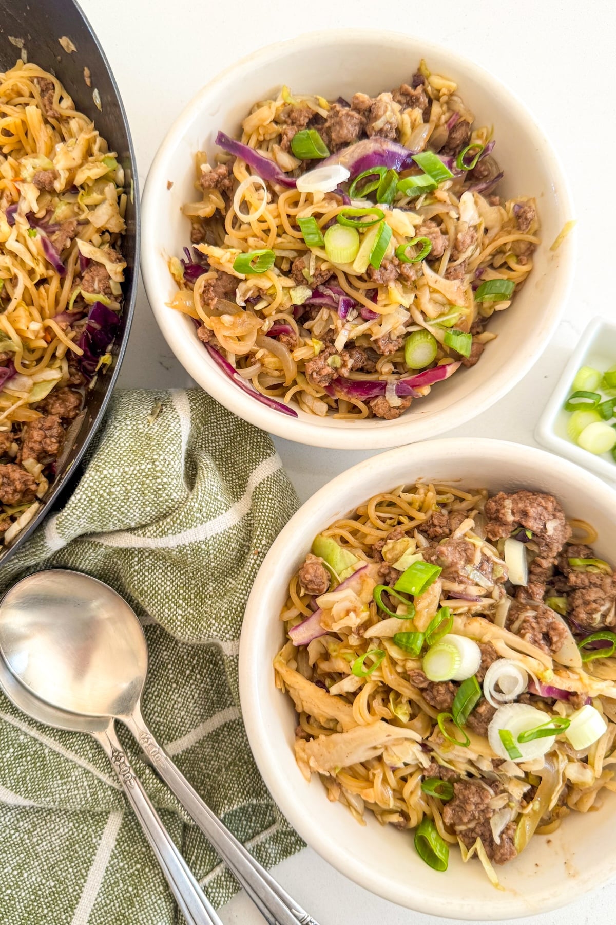 serving egg roll in a bowl into white bowls