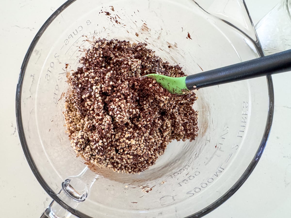 mixing crispy quinoa into chocolate