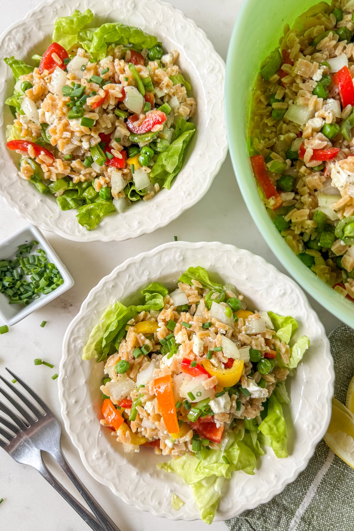 orzo pasta salad served in white bowls