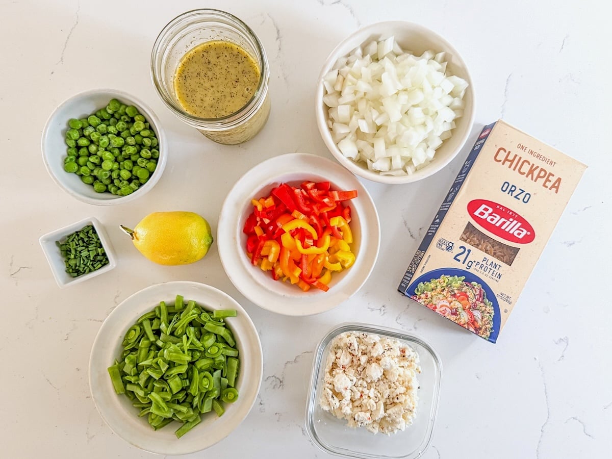 orzo pasta salad ingredients on marble