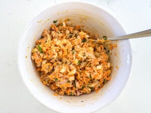 mixing tuna salad in a bowl