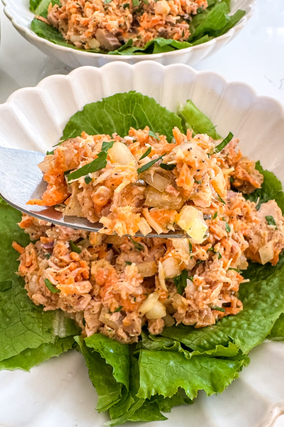 eating tuna salad with a fork