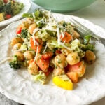 chopped salad with pesto vinaigrette on white plate